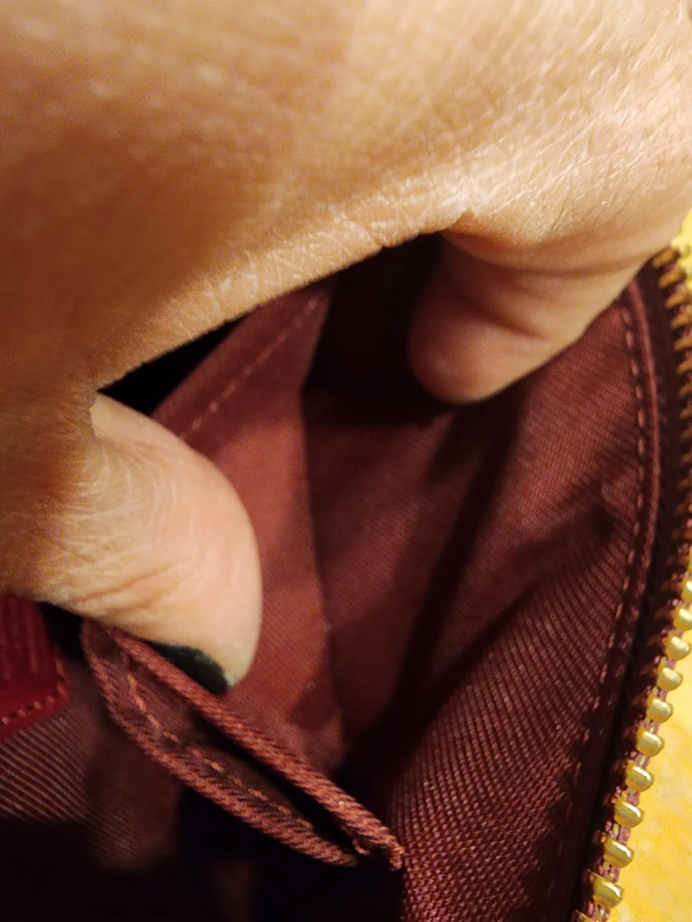 red polished pebble leather Coach wristlet, featuring gold-tone hardware
